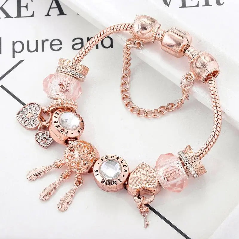 Rosa drømmefanger-armbånd med sølvcharms
